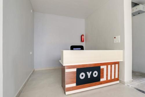 a reception desk with a sign that reads ovo at Collection O RBS ECIL in Hyderabad