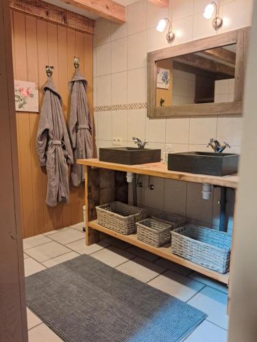 a bathroom with two sinks and a mirror at De Patuljak in Houffalize