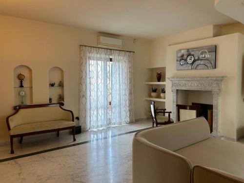 a living room with a couch and a fireplace at Villa Paola - appartamento Charme - in Sarzana