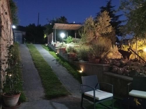a garden at night with a bench and a building at B&B da Maria Teresa - Maratea in Maratea