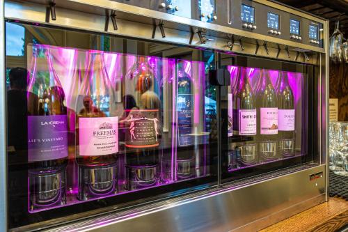 a display case filled with bottles of wine at Hotel E in Santa Rosa