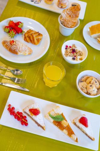 a table with plates of food on a table at Rock Crystal Boutique Hotel in Gabicce Mare