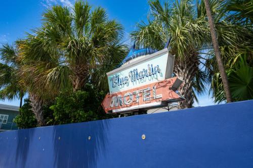 a sign for the blue mirage motel with palm trees at Blue Marlin Motel in Key West