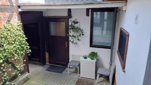 an entrance to a house with a door and chairs at Kaiserpfalzquartier in Goslar