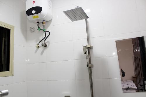 a shower in a bathroom with a camera on the wall at MY40 Hotel in Abuja