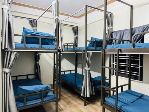a group of four bunk beds in a room at Opi Homestay in Làng Me