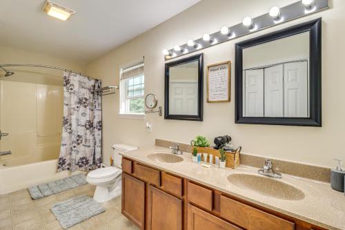 a bathroom with two sinks and a toilet and a shower at Family Retreat with 2 Game Rooms and Deck in Long Pond in Long Pond