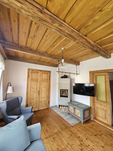 a living room with a couch and a fireplace at Chalupa JFD, Josefův Důl in Josefuv dul