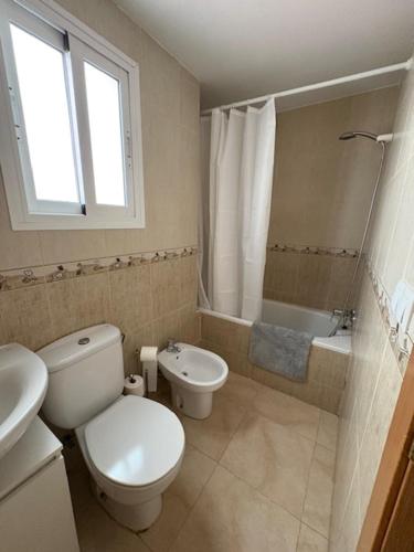 a bathroom with a toilet and a sink and a tub at Brisas de Guadalest in El Castell de Guadalest