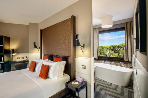 una camera d'albergo con un letto e una vasca da bagno di The Tribune, part of JdV by Hyatt a Roma