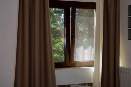 a window in a bathroom with a curtain next to it at B&B Nonna Iolanda in Camigliatello Silano