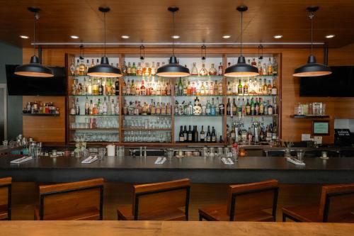 a bar with a lot of bottles of alcohol at The Heathman Hotel Kirkland in Kirkland