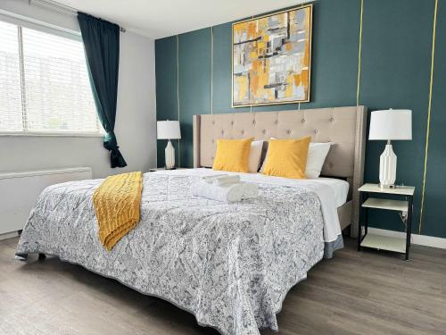 a bedroom with a large bed with yellow pillows at Downtown New-Built Roof-top balcony City View 525Pkwy in Atlanta