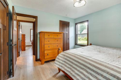 a bedroom with a bed and a dresser and a window at Sioux Falls Home Near Downtown 2 Living Areas! in Sioux Falls