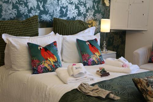 a bed with towels and pillows on it at West ave exeter in Exeter