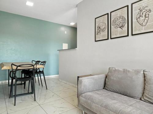a living room with a couch and a table at Condominio - Cotia - 2 QTS - sacada in Cotia