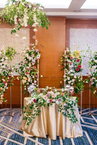 a table with flowers on it in a room at The Heathman Hotel Kirkland in Kirkland