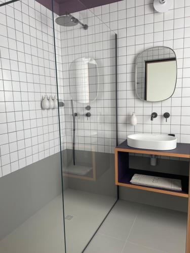 a bathroom with a sink and a mirror at Casa Oblò in Mendrisio