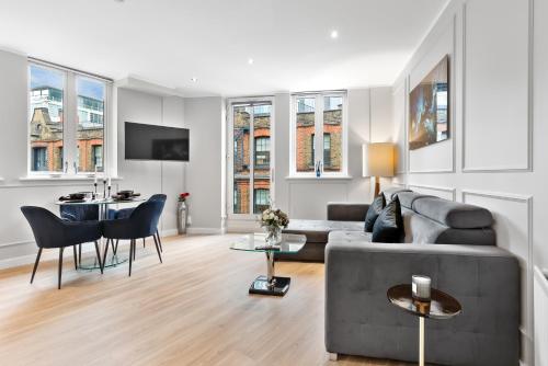 a living room with a couch and a table at The Liverpool Street Boutique in London