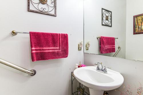 a bathroom with a sink and a mirror at 11 Mi to Dtwn Aberdeen Spacious Townhome! in Abingdon
