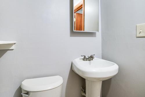 a white bathroom with a sink and a toilet at 11 Mi to Dtwn Aberdeen Spacious Townhome! in Abingdon