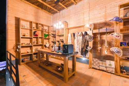 a room with a table and shelves with baseball equipment at Kawa Bamboo Retreat in Pereira