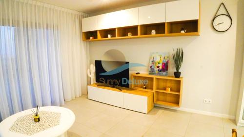 a room with a store with a clock on the wall at Alvorada Premium by Sunny Deluxe in Albufeira