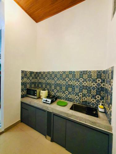 a kitchen with a sink and a counter top at Cliff House Bali With Private Pool in Sukasada