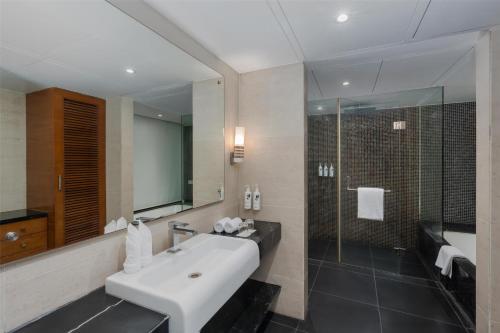 a bathroom with a white sink and a shower at Country Inn & Suites By Radisson Navi Mumbai in Navi Mumbai