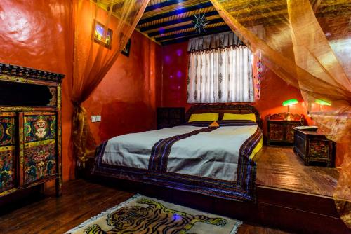 a bedroom with a bed in a red room at House Of Shambhala in Lhasa