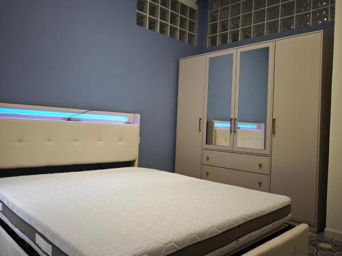 a small bedroom with a bed and a cabinet at La DIMORA del BORGO Apartment in Casalbuono