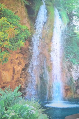 a painting of a waterfall in a forest at Apartament u Gabrysi in Piechowice