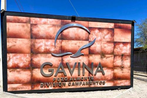 a sign for a gymnasium with a dolphin on it at Gavina División Campamento Pozo Almonte in Pozo Almonte