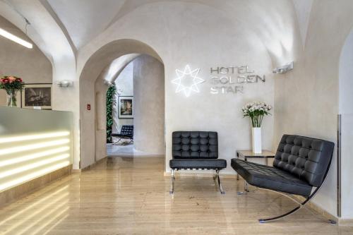 a salon with two chairs and a sign that reads hotel golden star at Golden Star in Prague