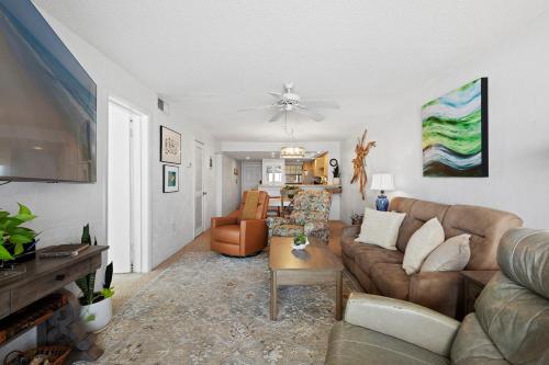 a living room with a couch and a table at 512 - Oceanfront top floor corner 2 bedroom in New Smyrna Beach