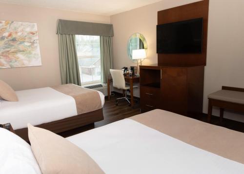 a hotel room with two beds and a television at D. Hotel Suites & Spa in Holyoke