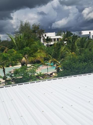 a view from the roof of a house with palm trees at The soul in Paje