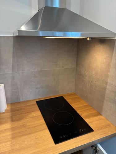 a kitchen with a stove top on a wooden counter at Studio number 5 in Pantin