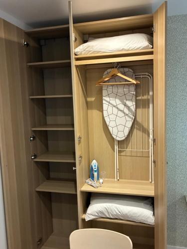 a walk in closet with a wooden closet organizer at Studio number 5 in Pantin