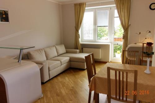 a living room with a couch and a table at Apartment Old Town Riga River View in Rīga