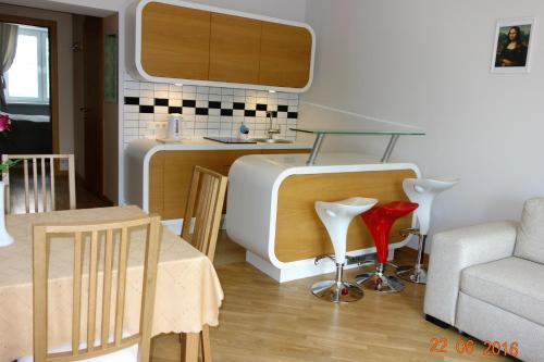 a kitchen with a glass table and a couch at Riga Old Town River View with balcony in Rīga