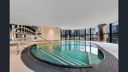 a large building with a pool in the middle at 14D Abnb-Style Elegant CBD Sanctuary with Balcony, Pool and Skyline Views in Melbourne