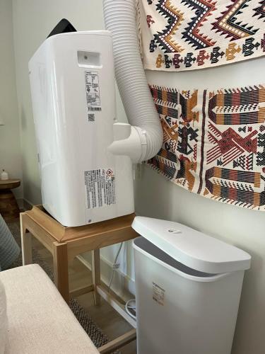 a washing machine sitting on a table next to a toilet at La Casa de Tutti in Decatur