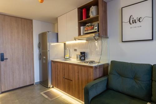 a kitchen with a refrigerator and a chair in a room at Luxury loft with a view and balcony Norte Armenia in Armenia