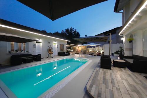 a swimming pool in front of a house at night at Apt 4 Borgo Lago di Garda in Lonato del Garda