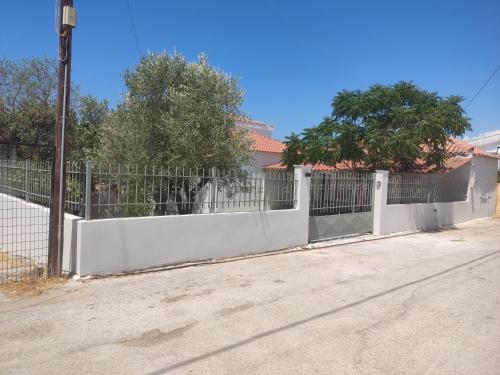 a white fence in front of a house at Casa Maria Porto Cheli in Porto Heli