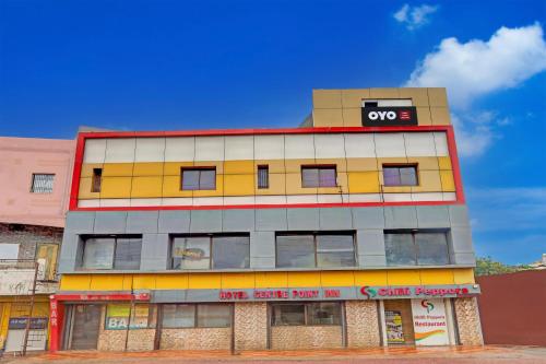 a building with an oops sign on top of it at SPOT ON Hotel Center Point Inn in Bhilai