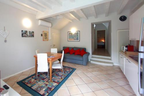 a living room with a table and a couch at Apt 5 Borgo Lago di Garda in Lonato del Garda