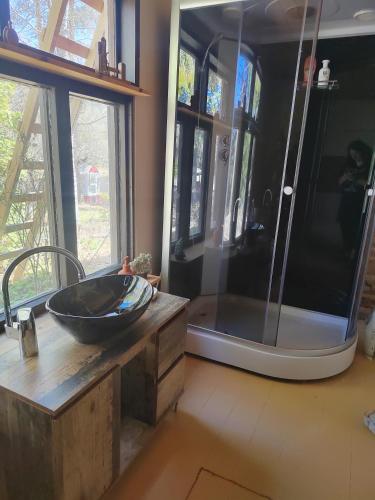 a bathroom with a sink and a shower at Riverside Cottage Äänekoski Sauna Hot Tub Northern Lights in Äänekoski