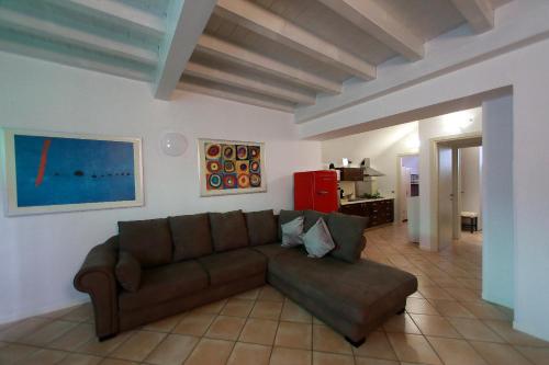 a living room with a brown couch in a room at Apt 6 Borgo Lago di Garda in Lonato del Garda